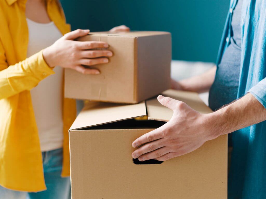 Couple packing up boxes